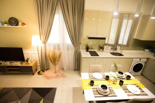 a living room with a table and a kitchen at Paradigm Residence By The one - upstair of paradigm mall JB in Johor Bahru