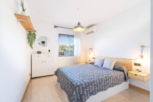 a small bedroom with a bed and a window at 1ºlineaMar-exclusive-BBQ-wifi-Relax-PortAventura6 in Salou