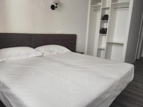 a white bed with two pillows in a bedroom at HOSTAL GOLDEN 21*** in Madrid