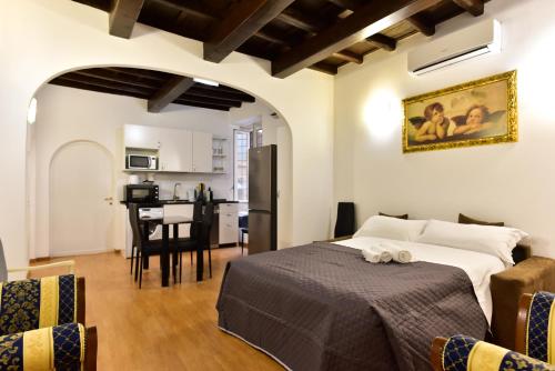 a bedroom with a bed and a kitchen in a room at Elite Rome apartments 3 in Rome