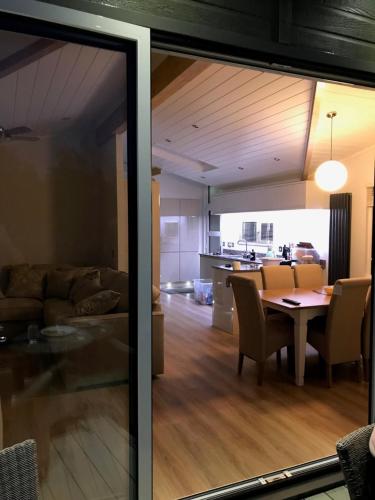a living room and dining room with a table and a kitchen at R11 Lake View, Fallbarrow Holiday Park in Bowness-on-Windermere