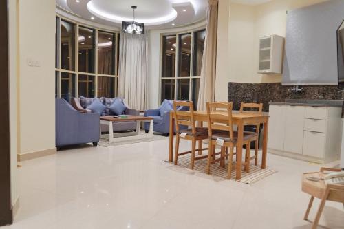 a kitchen and living room with a table and chairs at سما الرفاع 3 in Al Kharj