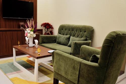 a living room with two chairs and a table at سما الرفاع 3 in Al Kharj