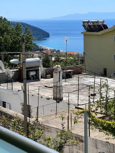 a view of a building with a view of the ocean at Oscar’s Apartments Drymades in Dhërmi