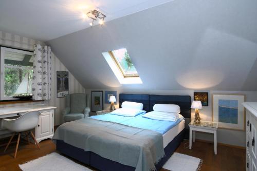 a bedroom with a bed with a blue bedspread at Pension Kalmus in Smołdziński Las