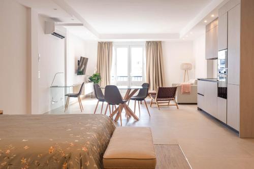 a room with a bed and a table and chairs at Rooms & Suites Loft 2F Deluxe Edition Arrecife in Arrecife