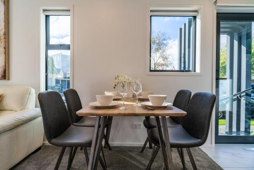 a dining room with a wooden table and chairs at King bed on Hagley Park corner in the CBD in Christchurch