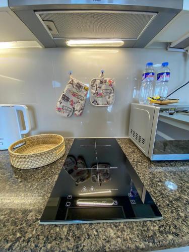 a kitchen with a counter top with a stove at nJoy! BOHO Luxury at Venice Grand Canal - perfect for business & couples in Manila
