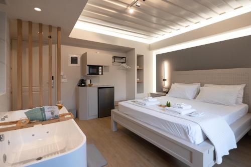 a bedroom with a large bed and a bathtub at Hanim Boutique Hotel in Chania Town