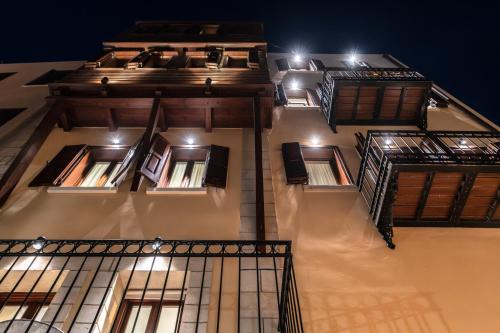 a tall building with windows and lights on it at Hanim Boutique Hotel in Chania Town