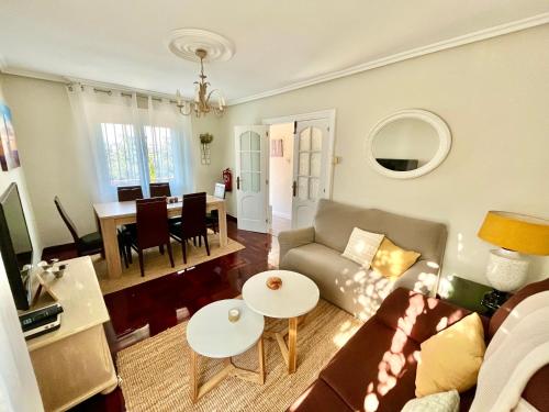 a living room with a couch and a table at La Casa de la Buganvilla in Gijón