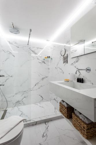 a white bathroom with a sink and a toilet at Seaside Apartment by Flisvos Marina in Athens