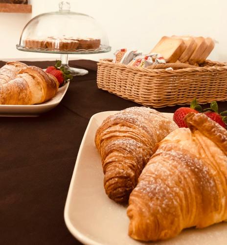 a table with croissants and pastries on a plate at La casa dei nonni in San Salvo