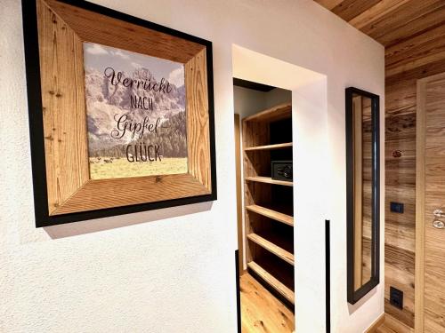 a painting on a wall next to a closet at Boutique Hotel Längenfelder Hof in Grainau