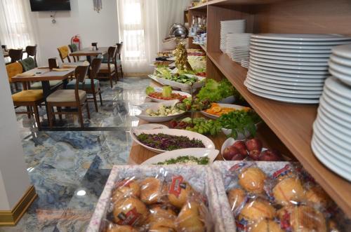 a buffet line with plates and bowls of food at Marka Hotel in Antalya