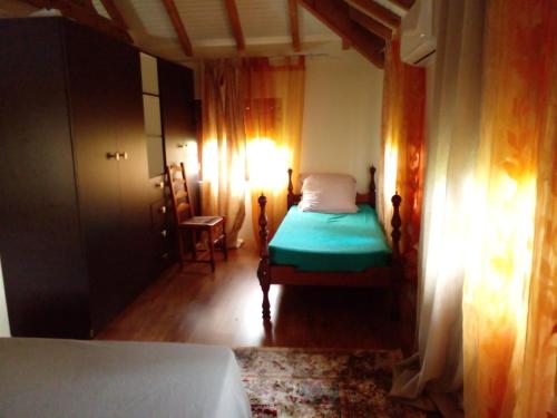a small bedroom with a bed and a lamp at La Villa Belle in La Trinité