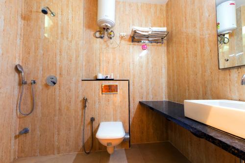 a bathroom with a sink and a toilet at The Vegas By De Pavilion, Delhi Airport in New Delhi