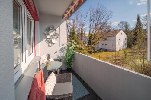 a balcony with a table and chairs and a window at Berg Apartments in Oberreichenbach