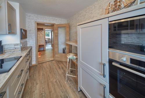 a kitchen with a white refrigerator and a counter at Berg Apartments in Oberreichenbach