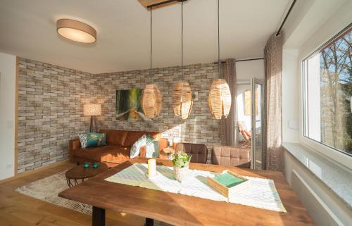 a living room with a table and a couch at Berg Apartments in Oberreichenbach