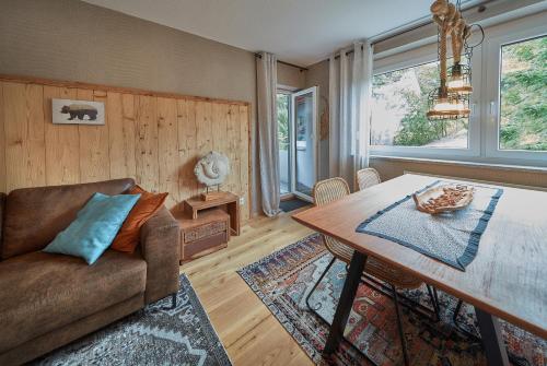 a living room with a couch and a table at Berg Apartments in Oberreichenbach