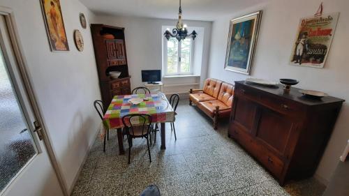 a living room with a table and a couch at La Casalina dell'Elba in Marciana