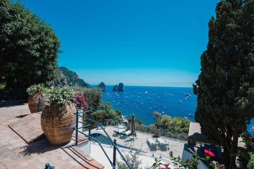 a view of the ocean with two large potted plants at Villa Danima in Capri