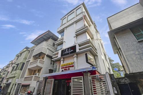a tall white building with a sign on it at Super Collection O Avenue Regency Near Kalighat Kali Temple in Kolkata