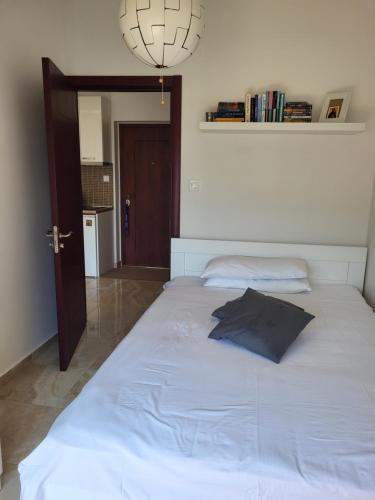 a bedroom with a large white bed with a blue pillow at House Tamaris App.25 in Ðenovići