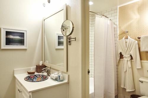 a bathroom with a sink and a shower with a mirror at Laguna Beach House in Laguna Beach