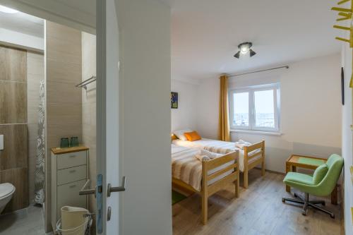 a small bedroom with a bed and a bathroom at App Sophia in Pula