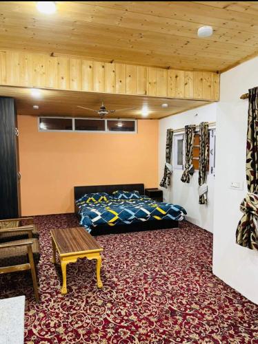 a bedroom with a bed and a wooden ceiling at Ashai Villa Studio Apartment in Srinagar in Srinagar