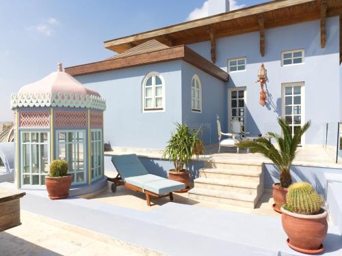 a house with a gazebo and potted plants at La Maison Bleue El Gouna in Hurghada