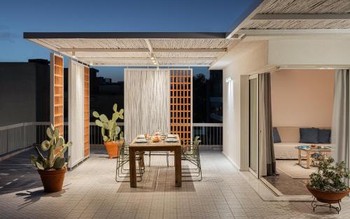 a patio with a table and chairs on a balcony at Sea View Beach Penthouse - Athens Coast in Athens