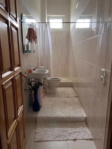 a bathroom with a toilet and a sink at Rest and go on in Khashuri