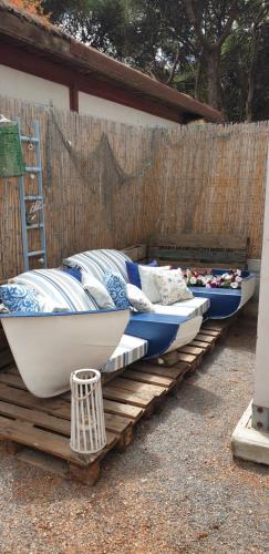 a row of beds sitting on a wooden deck at Casa Cristina in Porto Pino