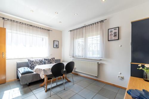 a living room with a couch and a table at Villa & Domek Maja in Sarbinowo