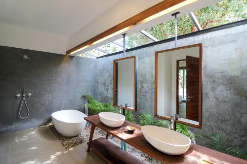 a bathroom with two sinks and two mirrors at ISLAND CENTER POINT in Koh Rong Sanloem