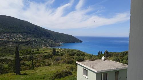 a house on a hill with a view of the ocean at Aelia Boutique Apartments in Argostoli