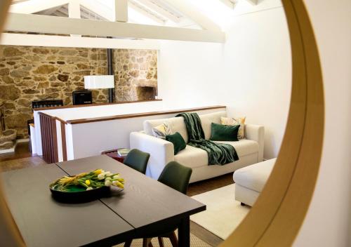 a living room with a table and a couch at Espigueiro - Casas de Selim in Arcos de Valdevez