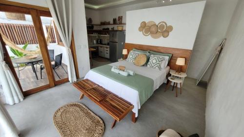 a bedroom with a bed and a table and chairs at BG Sol e Mar - Chalé Mar in Barra Grande