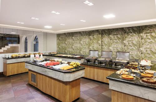 a buffet line with many different types of food at Miramar Hotel in Balneário Camboriú