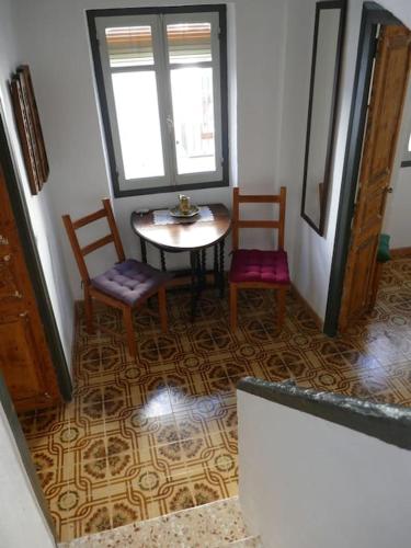 a dining room with a table and two chairs at Casa Azul, centro histórico de Calig (Peniscola) in Cálig