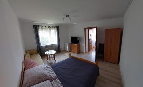 a bedroom with a bed and a table in it at Apartament Muszelka in Puck