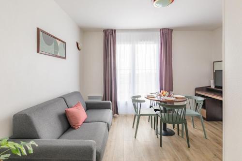 a living room with a couch and a table at Appart'City Confort Brest in Brest