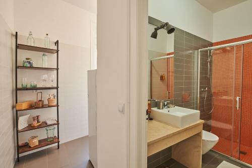 a bathroom with a toilet and a sink and a shower at The Blue Sky Nest in Lisbon