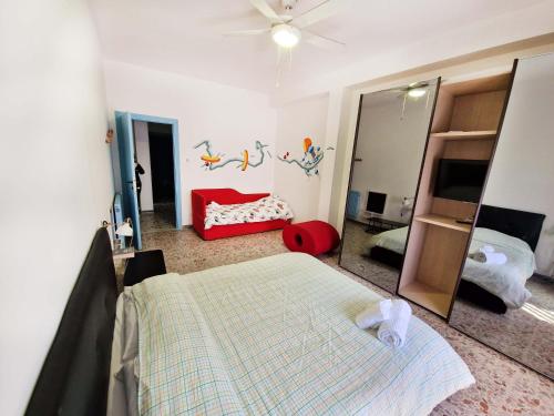 a bedroom with a bed and a mirror at Un letto a Gaeta - Appartamento a Serapo via Bologna in Gaeta