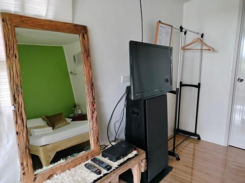 a mirror in a room with a tv and a couch at Casas del Salvador (Airbnb) Private Room #9 in Valencia