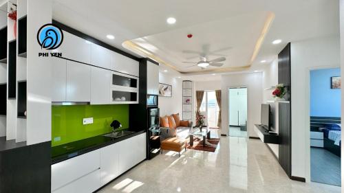 a living room with a green accent wall in a house at Phi Yen Muong Thanh 04 Apartment in Nha Trang