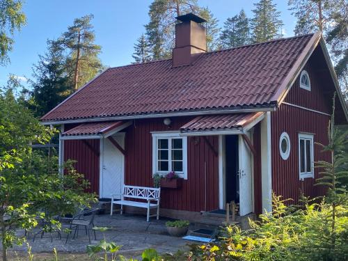 a red house with a chimney on top of it at Villa Tammikko in Tuusula